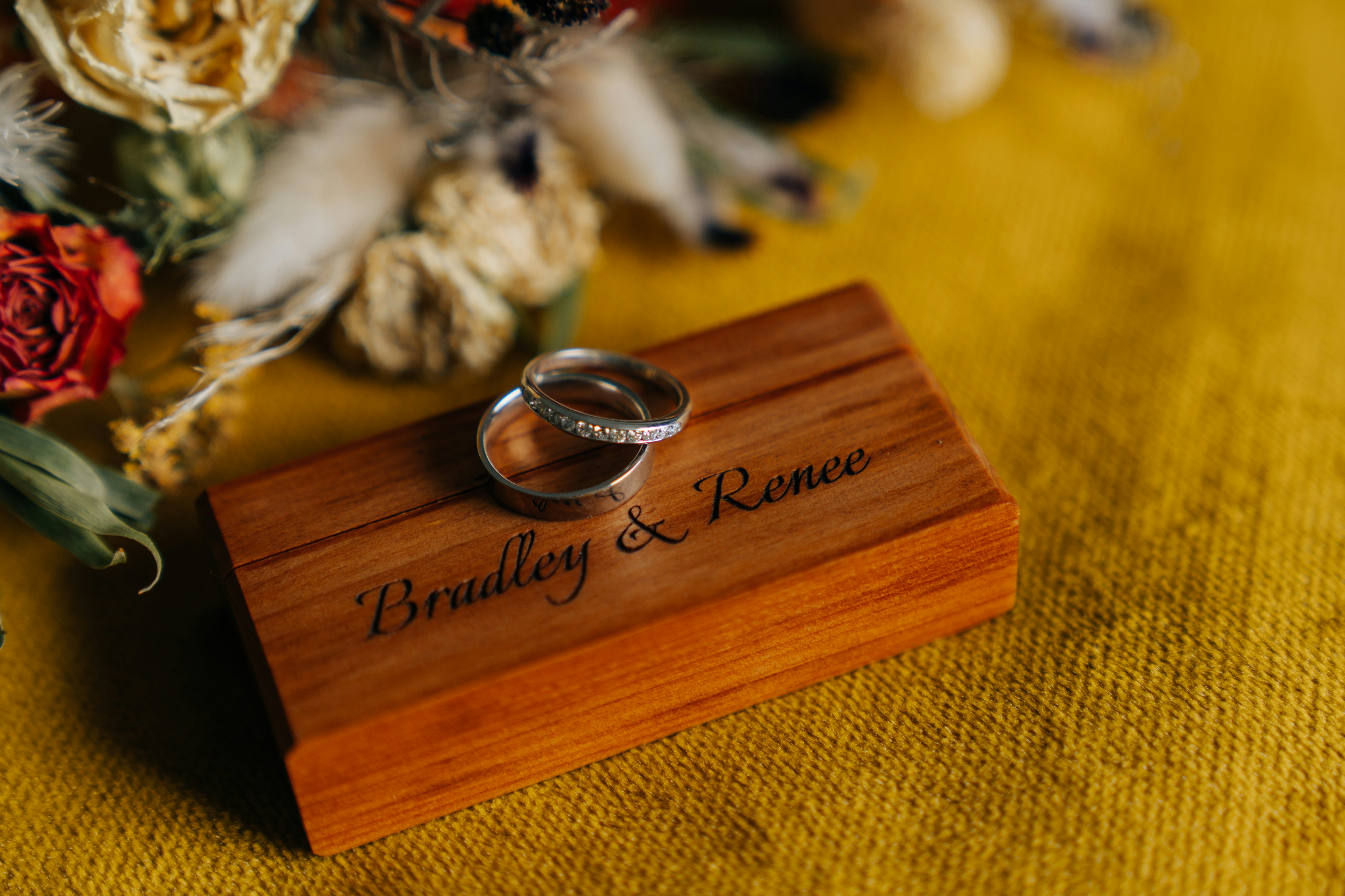 silver round coin on brown wooden box